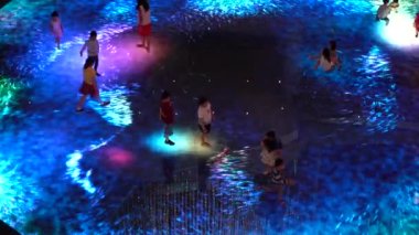 SINGAPORE CITY, SINGAPORE - MARCH 29, 2019: Large screen augmented reality experience on the floor. Children playing on Digital Light Canvas at Marina Bay Sands mall in Singapore
