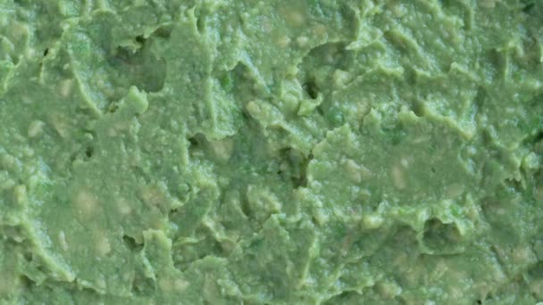 Fresh Green Avocado Pulp Rotates Background Texture Raw Mashed Avocado — Vídeos de Stock