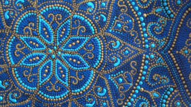 Decorative ceramic plate with blue and golden colors, painted plates, close up, rotates, handmade. Decorative porcelain plate painted with acrylic paints, handwork