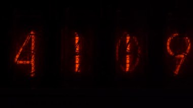 Retro vacuum tube display on the device counts seconds. Displaying numbers on a vintage lamp timer, close up, nixie tube indicator. Glow discharge indicator