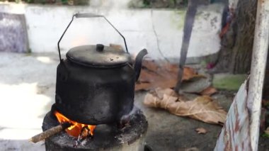 Old kettle on bonfire of countryside, close up, Vietnam 