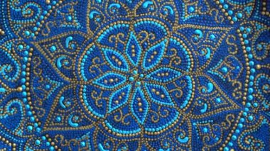 Decorative ceramic plate with blue and golden colors, painted plates, close up, rotates, handmade. Decorative porcelain plate painted with acrylic paints, handwork