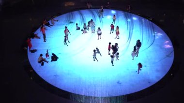 SINGAPORE CITY, SINGAPORE - MARCH 29, 2019: Large screen augmented reality experience on the floor. Children playing on Digital Light Canvas at Marina Bay Sands mall in Singapore