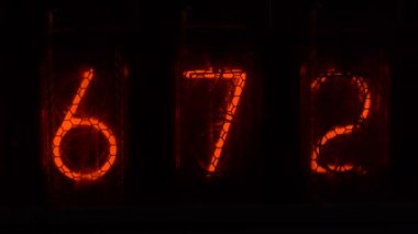 Retro vacuum tube display on the device counts seconds. Displaying numbers on a vintage lamp timer, close up, nixie tube indicator. Glow discharge indicator