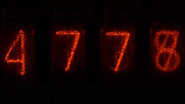 Cihazın üzerindeki vakum tüpü görüntüsü saniyeleri sayıyor. Vintage lamba zamanlayıcısında numaralar gösteriliyor, yakın çekim, nixie tüpü göstergesi. Parlama deşarj göstergesi