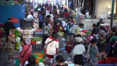 UBUD, BALI, INDONEZYA - 24 Nisan 2019: Endonezyalı fakir insanlar, Endonezya 'nın Bali adasındaki Ubud köyündeki sabah pazarında sağlıklı yiyecek satıyor ve satın alıyorlar. Sabah meyve ve sebze pazarı