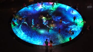SINGAPORE CITY, SINGAPORE - MARCH 29, 2019: Large screen augmented reality experience on the floor. Children playing on Digital Light Canvas at Marina Bay Sands mall in Singapore