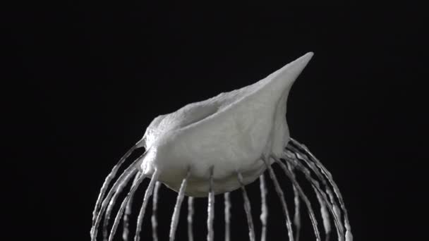 Metal Whisk Whipped Egg Whites Isolated Black Background Close Rotates — стоковое видео