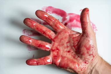 Man's hand in sweet red cherry jam, close up, top view