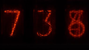 Retro vacuum tube display on the device counts seconds. Displaying numbers on a vintage lamp timer, close up, nixie tube indicator. Glow discharge indicator