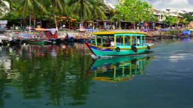 Hoi An, Vietnam - 29 Haziran 2020: Vietnamlılar Hoi Nehri kıyısındaki ahşap bir teknede yüzüyorlar.