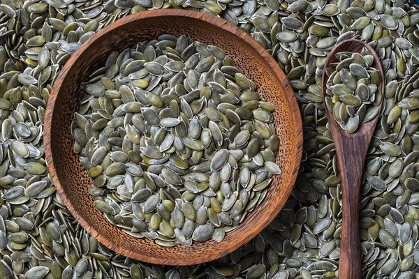 Raw Green Pumpkin Seeds Background Wooden Bowl Andspoon Food Texture — Stockfoto