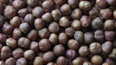 Dry hazelnuts background. Heap of peeled hazelnuts kernels rotating, top view , close up