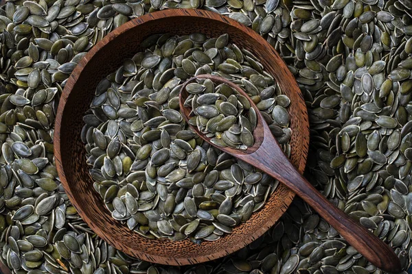 Raw Green Pumpkin Seeds Background Wooden Bowl Andspoon Food Texture — Stockfoto