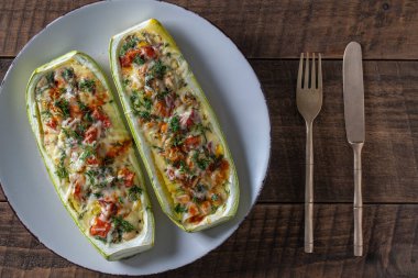 Zucchini stuffed with shrimps, vegetables and cheese. Baked zucchini boats, copy space, top view, close up