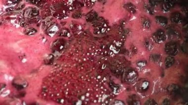 Preparation of freshly picked red cherries with sugar to make cherry jam, close up, top view. Cooking homemade cherry fruit jam in a saucepan