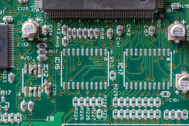 Old printed circuit board background. Vintage circuit board with soldering trace, close up, top view. Backside brown electronic chip retro style design