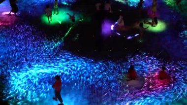 SINGAPORE CITY, SINGAPORE - MARCH 29, 2019: Large screen augmented reality experience on the floor. Children playing on Digital Light Canvas at Marina Bay Sands mall in Singapore