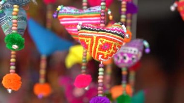 Colorful handmade souvenirs for sale in local street market in mountain village Sapa, Vietnam, close up