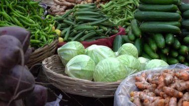 Food trader selling vegetables in the street market in holy city Udaipur, Rajasthan, India