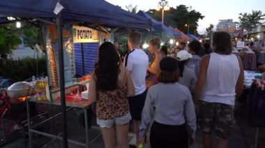 KOH PHANGAN, THAILAND - DECEMBER 29, 2018 : Street food : thai vendor sells food and ready meals at night food market in island Koh Phangan, Thailand