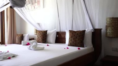 Lüks gösteriler için dekore edilmiş dört poster yataklı bir yazlık yatak odası. Denizdeki tropik villanın iç tasarımı, Zanzibar adası, Tanzanya, Afrika, çekim alanı