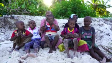 Zanzibar, Tanzania - december 12, 2019 : Young African girl and boy on the tropical beach in island of Zanzibar, Tanzania, east Africa, close up