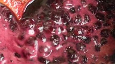 Preparation of freshly picked red cherries with sugar to make cherry jam, close up, top view. Cooking homemade cherry fruit jam in a saucepan