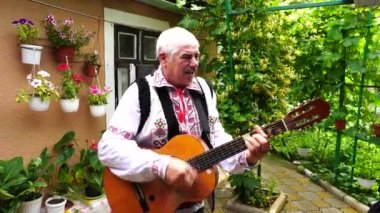 Dubossary, Transnistria, Moldova - june 20, 2021 : Moldovan man in national costumes sing for tourists in Dubossary, Transnistria, Moldova, close up