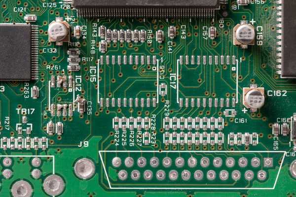 Old printed circuit board background. Vintage circuit board with soldering trace, close up, top view. Backside brown electronic chip retro style design