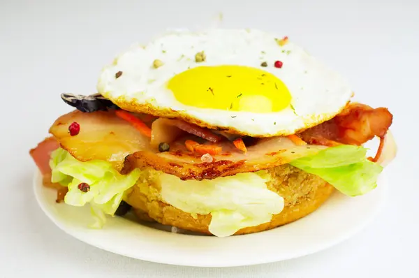 Burger with fried eggs and bacon — Stock Photo, Image