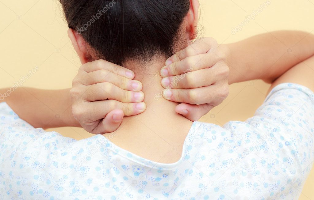 Woman holds a hand on neck  pain 