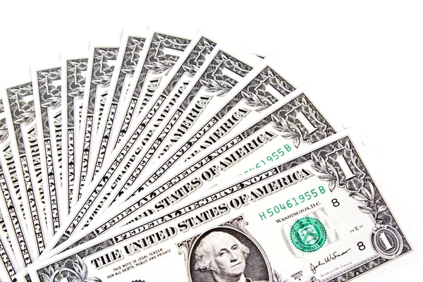 Dólares espalhados sobre fundo branco — Fotografia de Stock