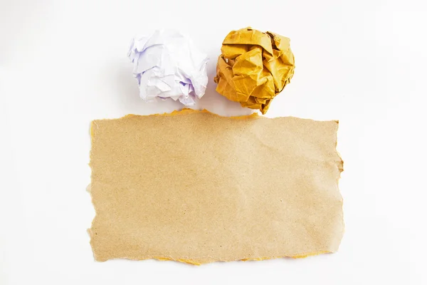 Crumble paper balls and brown paper on white background — Stock Photo, Image