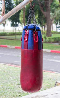 Boxing bags hanging at sports gym. clipart