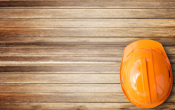 Top View Pomarańczowy Kask Bezpieczeństwa Brązowy Drewniany Stół Tło Miejsca — Zdjęcie stockowe
