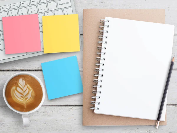 stock image Top view office desk with pink and yellow sticky note, coffee and notepad. Remote office and work from home concept.flat lay with copy space