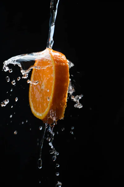 Slice Orange Doused Plenty Water Black Background — стоковое фото