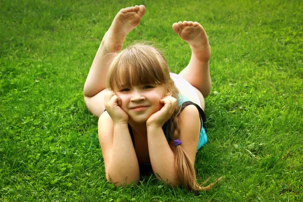 Little girl lying on grass — Stock Photo, Image