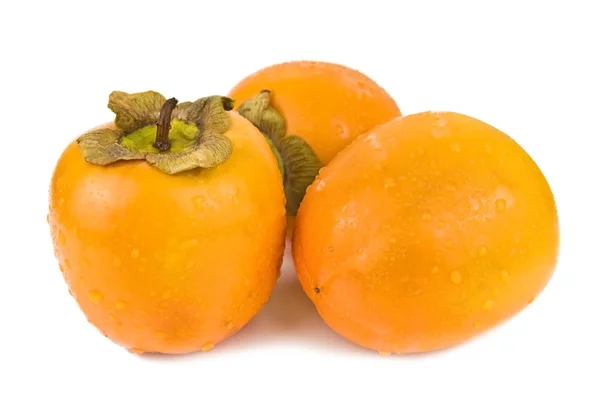 Три persimmons — стокове фото