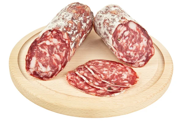 Delicious salami on wooden plank Stock Picture