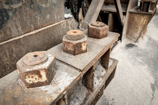 large rusty fasteners, screws and nut bolt fix the resistance of the metal bridge
