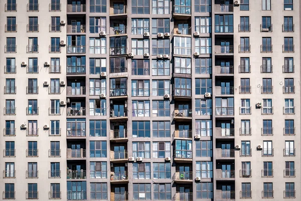 The facade of a multi-stored apartment building as a texture