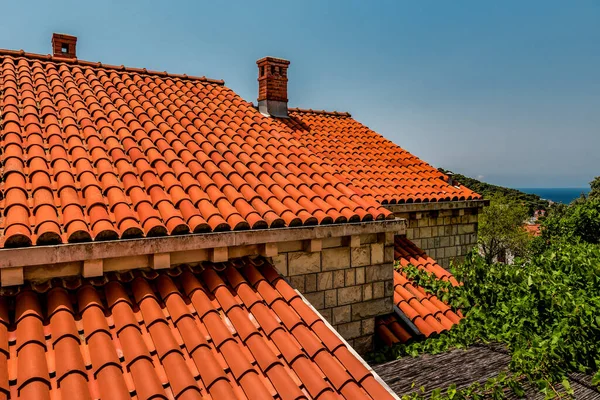 Mediterranean roofs with red tiles and blue sky. Croatian style, famous red tiled roof