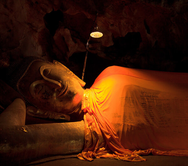 Old Buddha in a cave thailand