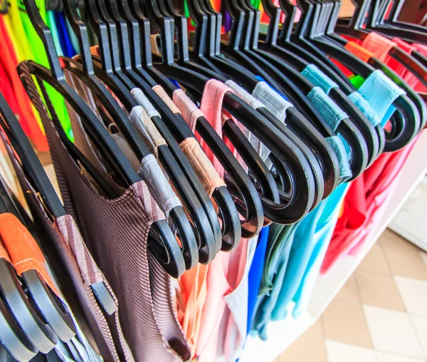Clothes hang on a shelf — Stock Photo, Image