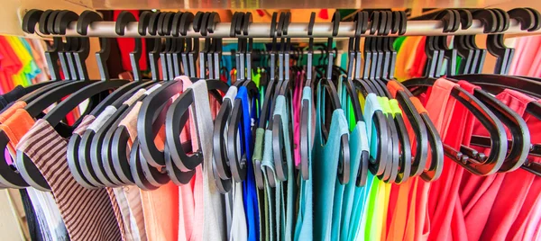 Clothes hang on a shelf — Stock Photo, Image