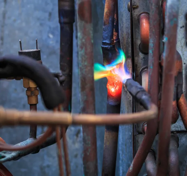 Welding copper pipes — Stock Photo, Image