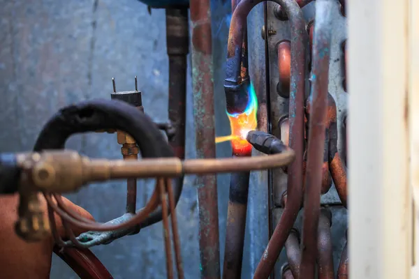 Welding copper pipes — Stock Photo, Image