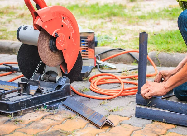 Worker cutting metal with grinder — Stock Photo, Image